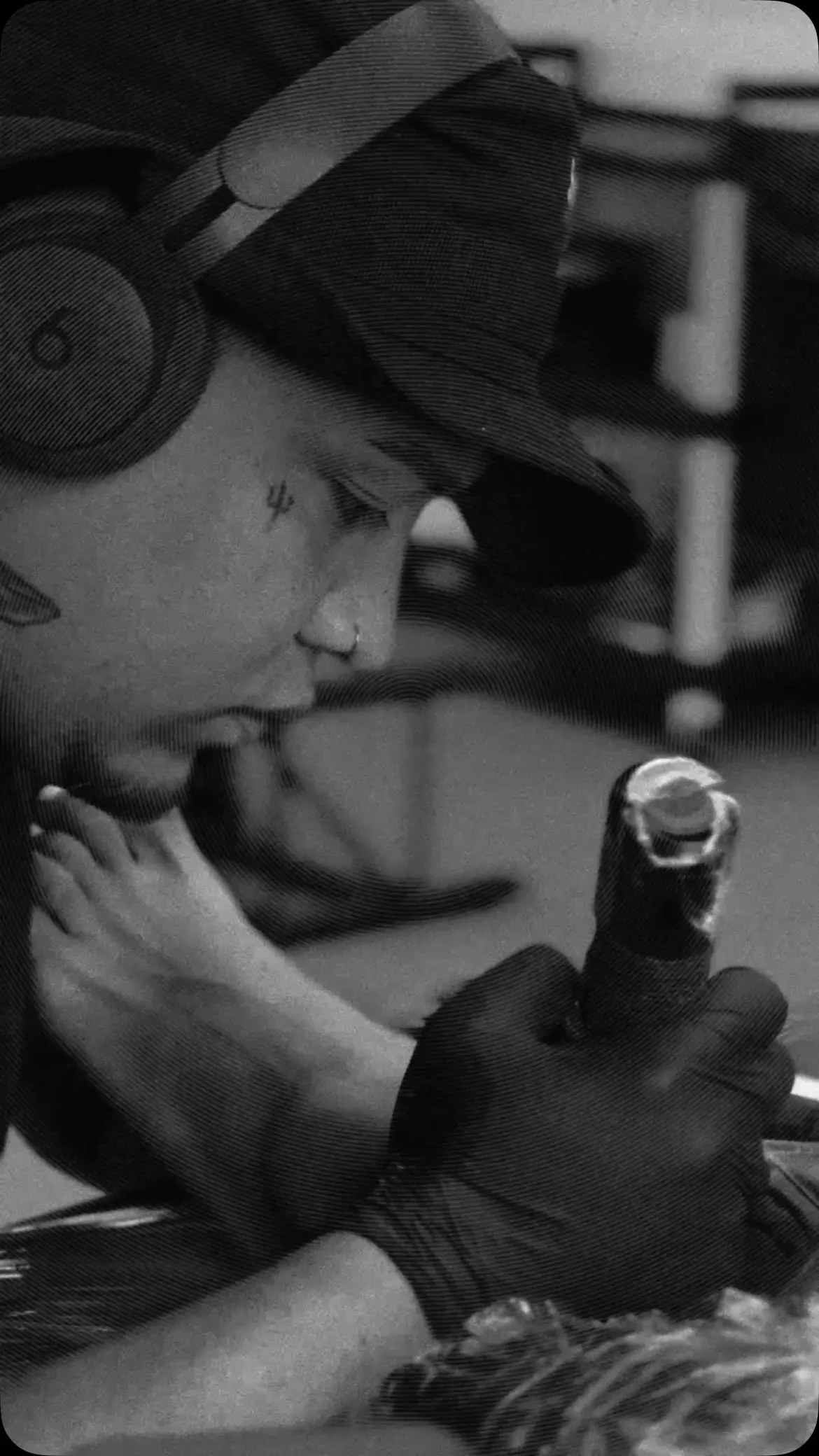 The artist tattooing, in black and white