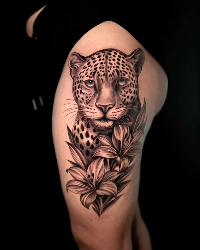 Black and grey leopard with lilies on an upper arm